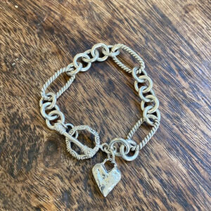 Detailed sterling silver chunky bracelet with a rustic heart